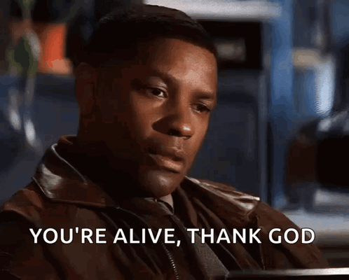 A Man Says " You 'Re Alive Thank God " While Sitting At A Table GIF
