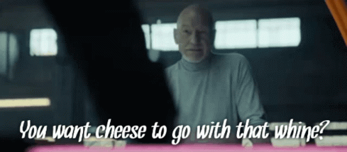 A Man Says " You Want Cheese To Go With That Whine " While Looking At Another Man GIF