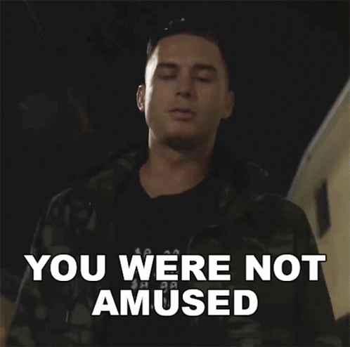 A Man Says You Were Not Amused While Standing In Front Of A Building GIF