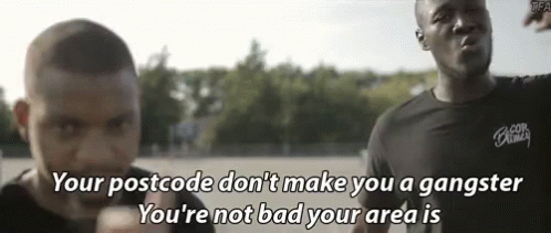 A Man Says " Your Postcode Don 'T Make You A Gangster You 'Re Not Bad Your Area Is " In Front Of Another Man GIF