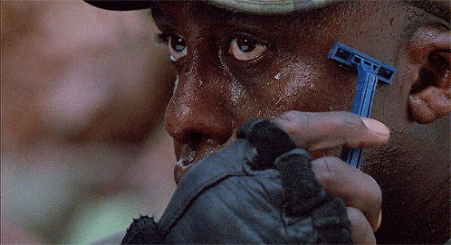 A Man Shaves His Face With A Blue Razor That Says Gillette On It GIF