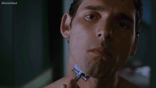 A Man Shaves His Neck With A Razor With Illusive Soul Written In The Upper Right Corner GIF