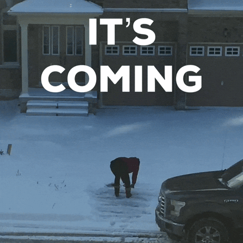 A Man Shoveling Snow In Front Of A House With The Words It 'S Coming Above Him GIF