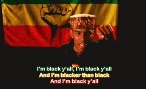 a man singing in front of a flag with the words i 'm black y all