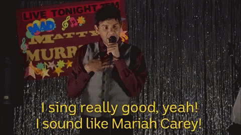A Man Singing In Front Of A Live Tonight Banner GIF