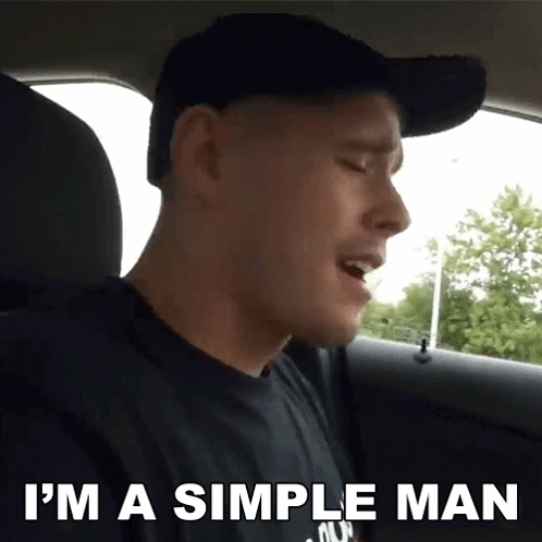 A Man Singing In The Back Seat Of A Car With The Words I 'M A Simple Man Above Him GIF