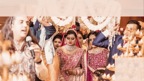 A Man Singing Into A Microphone In Front Of A Bride GIF