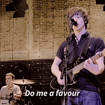 A Man Singing Into A Microphone While Playing A Guitar With The Words Do Me A Favour Below Him GIF