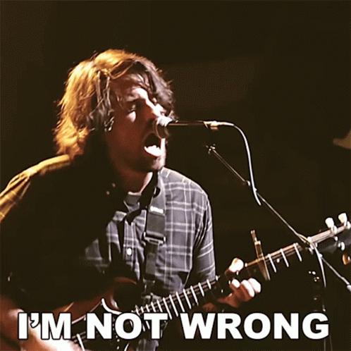A Man Singing Into A Microphone While Playing A Guitar With The Words " I 'M Not Wrong " Above Him GIF