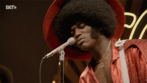 A Man Singing Into A Microphone With A Bet Logo In The Corner GIF