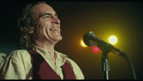 Man Singing Into Microphone With Smiley Face GIF