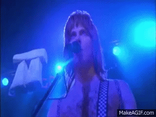 A Man Singing Into A Microphone With Makeagif.com In The Corner GIF
