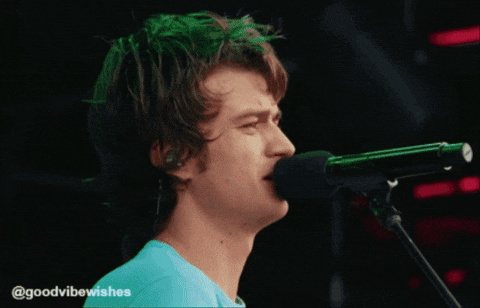 A Man Singing Into A Microphone With The Hashtag @Goodvibewishes At The Bottom GIF