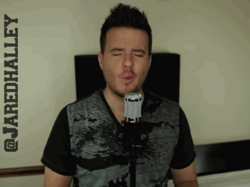 A Man Singing Into A Microphone With The Name Jaredhalley Written Above Him GIF