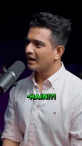 A Man Singing Into A Microphone With The Word Hain Written On His Chest GIF