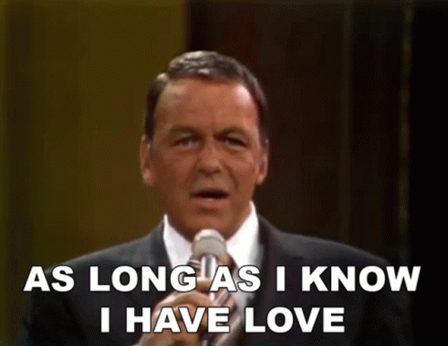 a man singing into a microphone with the words " as long as i know i have love " above him