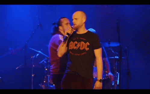A Man Singing Into A Microphone With The Words C Mon Guys C Mon Above Him GIF