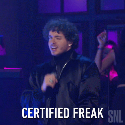 A Man Singing Into A Microphone With The Words Certified Freak Snl Below Him GIF