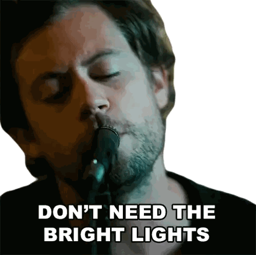 a man singing into a microphone with the words " do n't need the bright lights " written below him