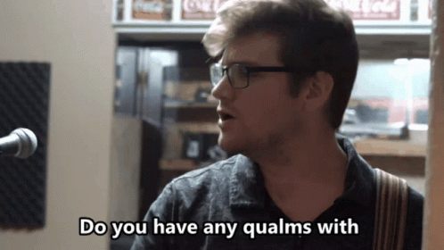 A Man Singing Into A Microphone With The Words Do You Have Any Qualms With GIF