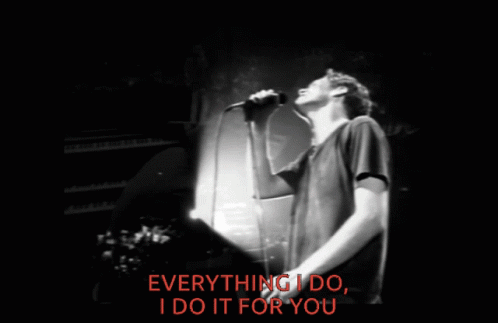 A Man Singing Into A Microphone With The Words Everything I Do I Do It For You Behind Him GIF