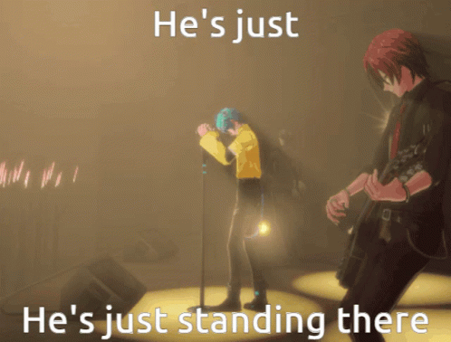 A Man Singing Into A Microphone With The Words He 'S Just He 'S Just Standing There On The Bottom GIF