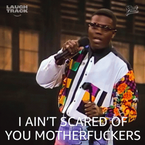 A Man Singing Into A Microphone With The Words I Ain T Scared Of You Motherfuckers GIF