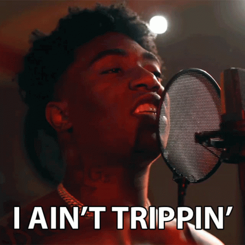 A Man Singing Into A Microphone With The Words " I Ain 'T Trippin ' " Below Him GIF