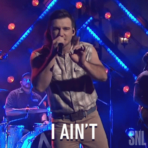 A Man Singing Into A Microphone With The Words " I Ain 'T " Written Below Him GIF