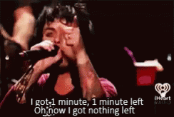 a man singing into a microphone with the words i got 1 minute , 1 minute left oh now i got nothing left