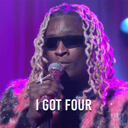 A Man Singing Into A Microphone With The Words " I Got Four " Above Him GIF
