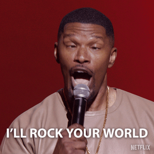 A Man Singing Into A Microphone With The Words " I 'Ll Rock Your World " Above Him GIF