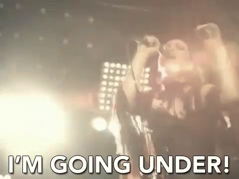A Man Singing Into A Microphone With The Words " I 'M Going Under " Written Below Him . GIF
