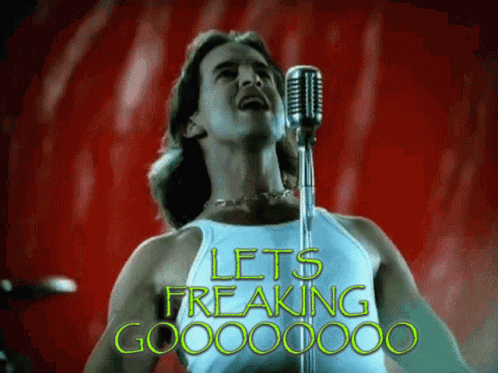 A Man Singing Into A Microphone With The Words Let 'S Freaking Go Written In Green GIF