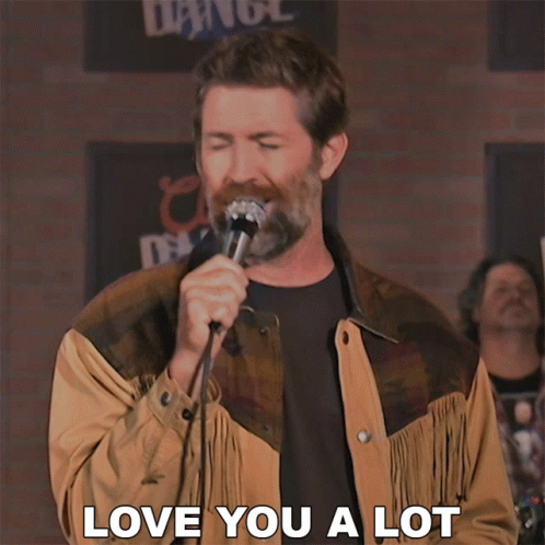 A Man Singing Into A Microphone With The Words Love You A Lot On The Bottom GIF