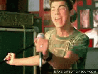 a man singing into a microphone with the words make gifs at gifsoup.com below