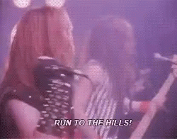 A Man Singing Into A Microphone With The Words Run To The Hills Written Below Him GIF