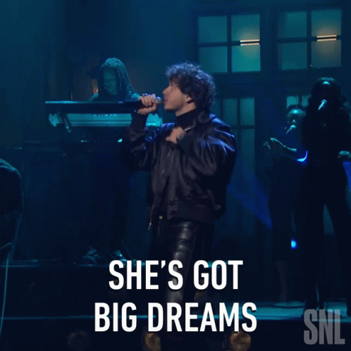A Man Singing Into A Microphone With The Words She 'S Got Big Dreams On The Bottom GIF