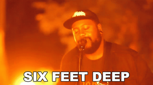 A Man Singing Into A Microphone With The Words Six Feet Deep Written Below Him GIF