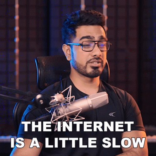 A Man Singing Into A Microphone With The Words " The Internet Is A Little Slow " Behind Him GIF