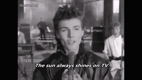 A Man Singing Into A Microphone With The Words The Sun Always Shines On Tv GIF