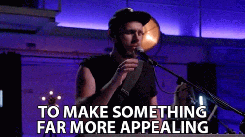 a man singing into a microphone with the words to make something far more appealing