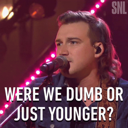 A Man Singing Into A Microphone With The Words Were We Dumb Or Just Younger On The Bottom GIF