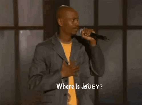 a man singing into a microphone with the words " where is jauey " written below him