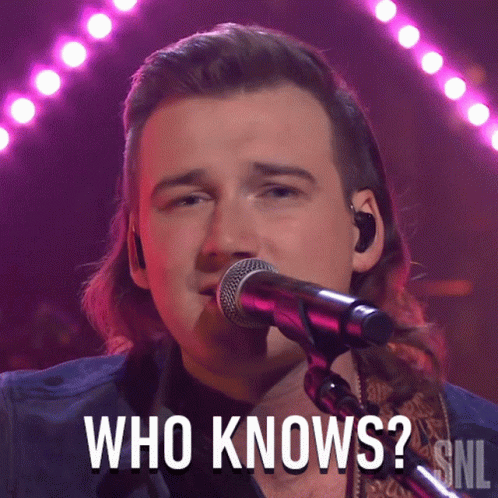 A Man Singing Into A Microphone With The Words Who Knows Above Him GIF