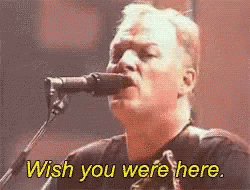 A Man Singing Into A Microphone With The Words Wish You Were Here Above Him GIF