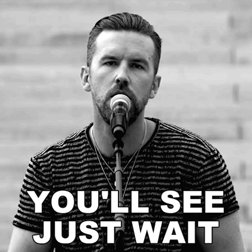 A Man Singing Into A Microphone With The Words You 'Ll See Just Wait Behind Him GIF