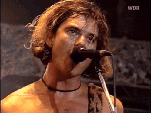 A Man Singing Into A Microphone With Wdr On The Bottom GIF