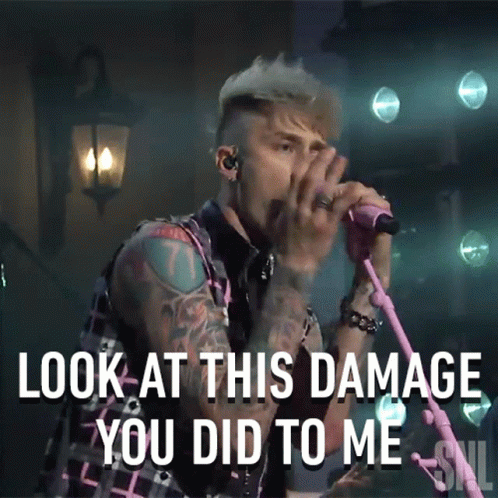 A Man Singing Into A Pink Microphone With The Words Look At This Damage You Did To Me Below Him GIF