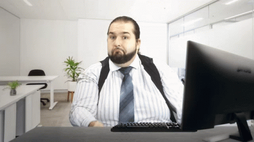 A Man Sits At A Desk With A Benq Monitor GIF